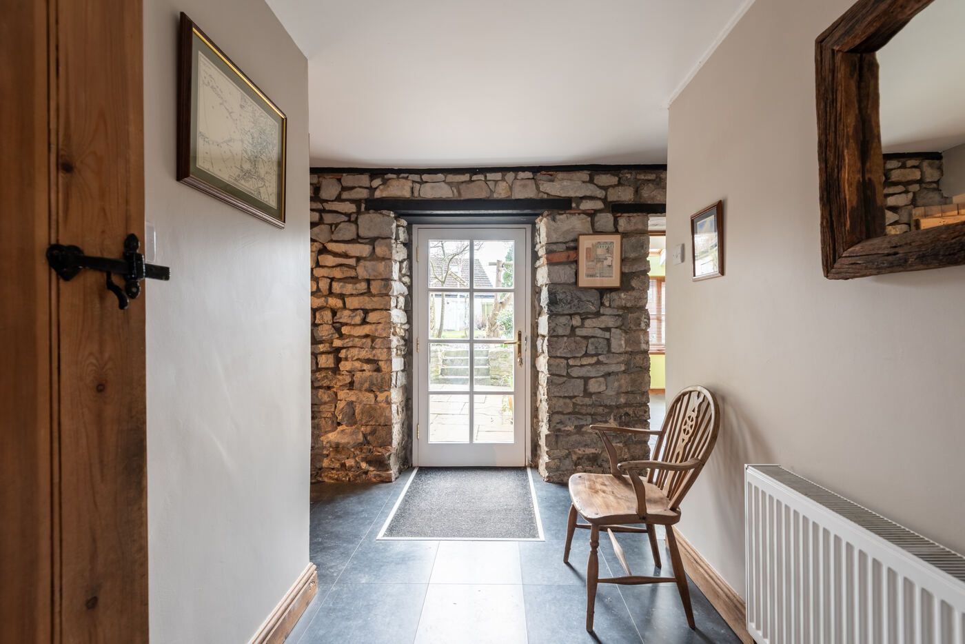 Stone-walled hallway leading to the back door