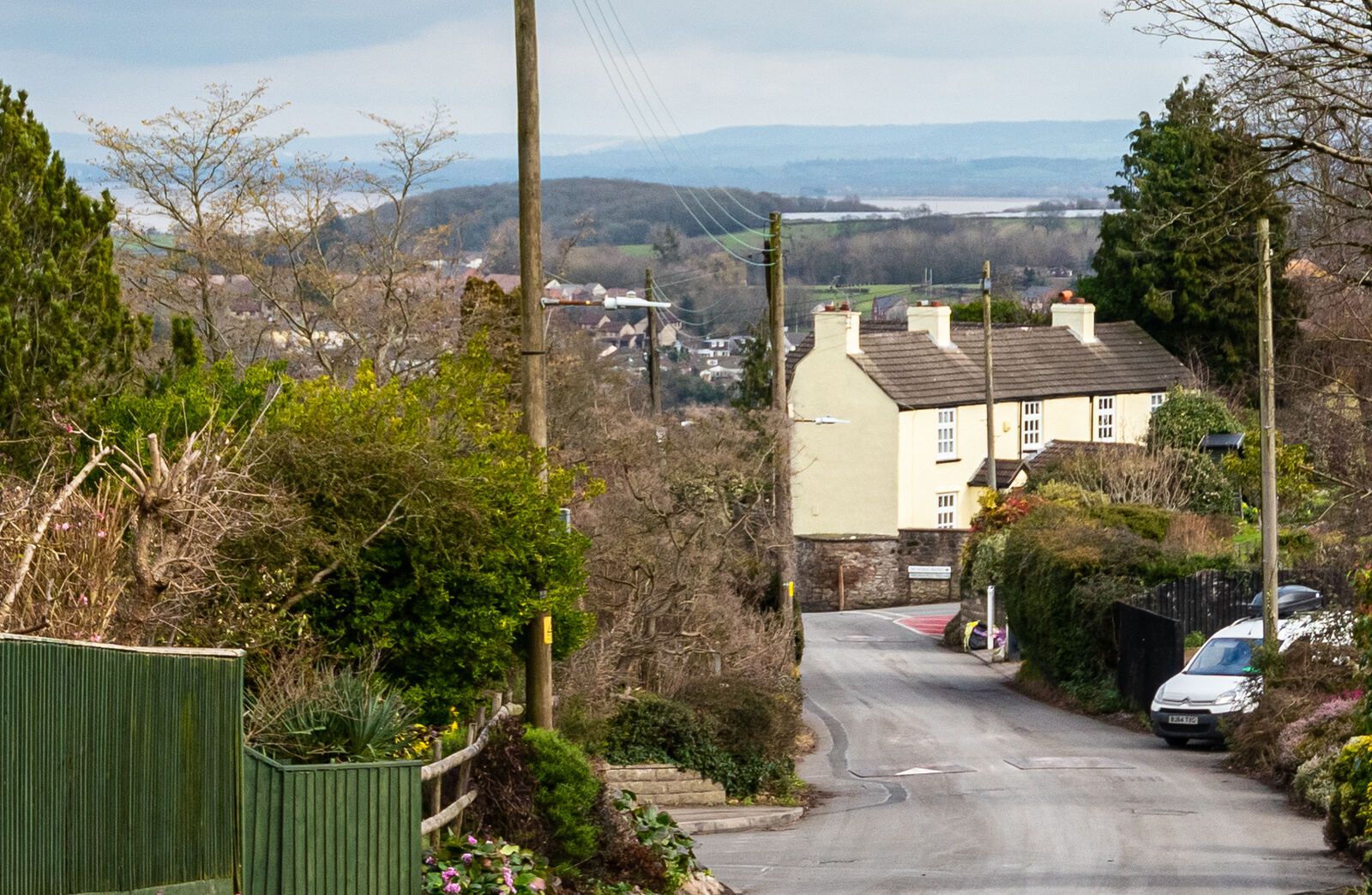 The lane down to Vauxhall Cottage with Chepstow town and the Severn Estuary beyond